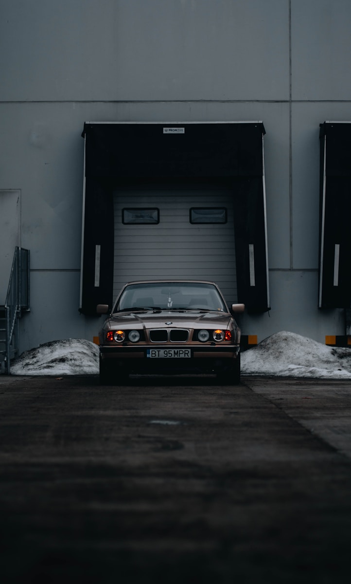 a car parked in front of a garage door